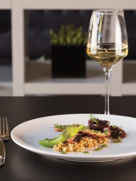 Plated dish on white porcelain with wine glass