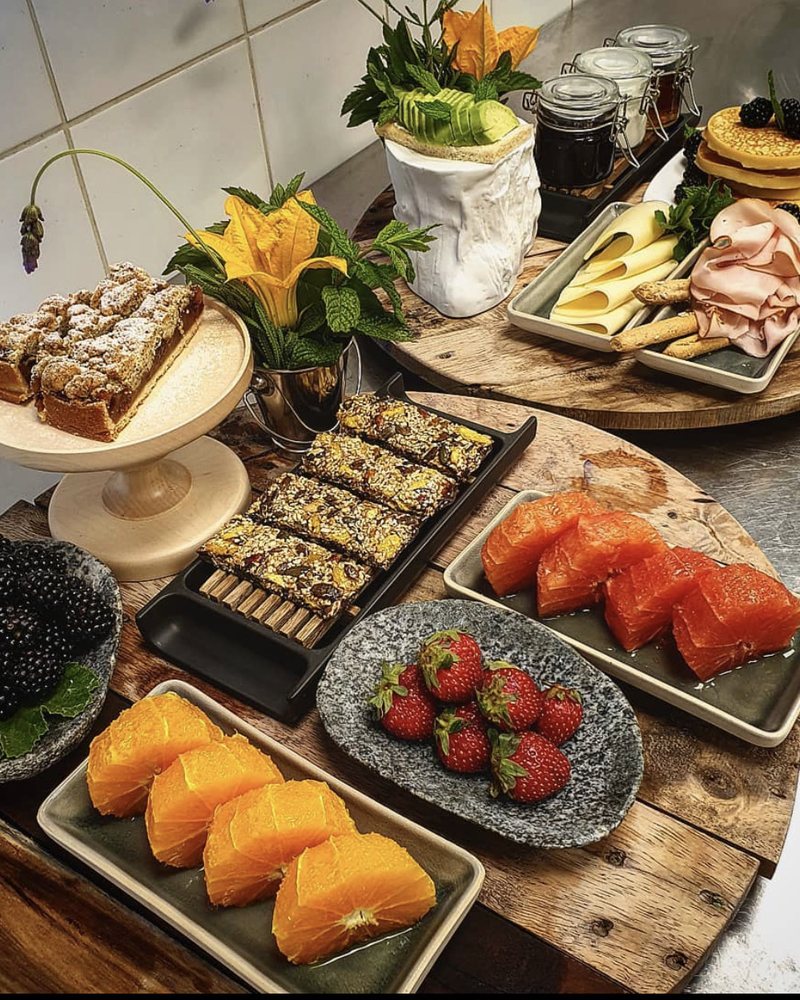 Buffet platters with fruit and cakes